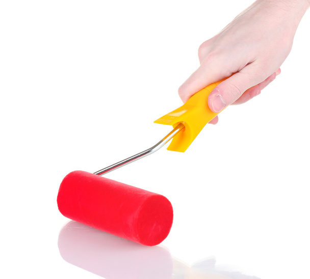 Bright paint roller in hand isolated on white - Φωτογραφία, εικόνα