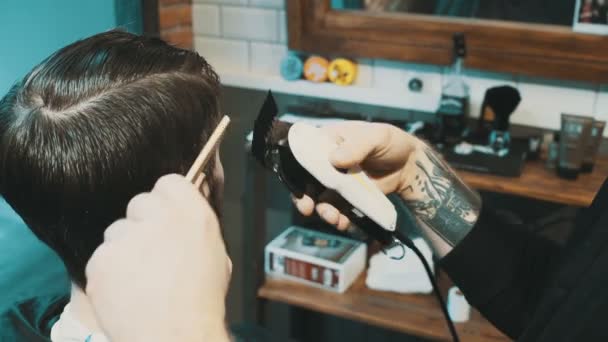 Friseur schneidet dem Kunden mit Haarschneidemaschine die Haare - Filmmaterial, Video