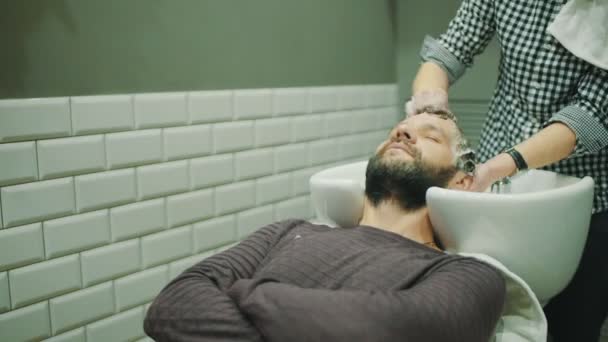 Barber wash customers hair - Footage, Video