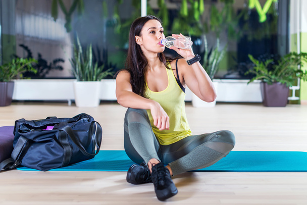 woman drinking water after training work - Photo, image