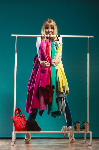 Funny woman taking all clothes in mall or wardrobe - Foto, immagini