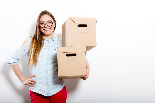 Happy woman moving into house carrying boxes. - Foto, Bild