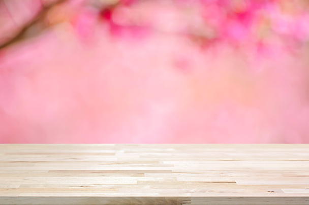 Wood table top on blurred background of pink cherry blossom flowers - Photo, Image