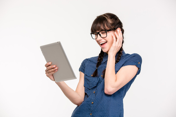 Laughing young woman using tablet computer  - Foto, Bild