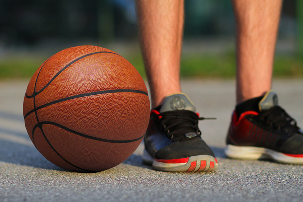 Basketball on the floor near player - Fotoğraf, Görsel