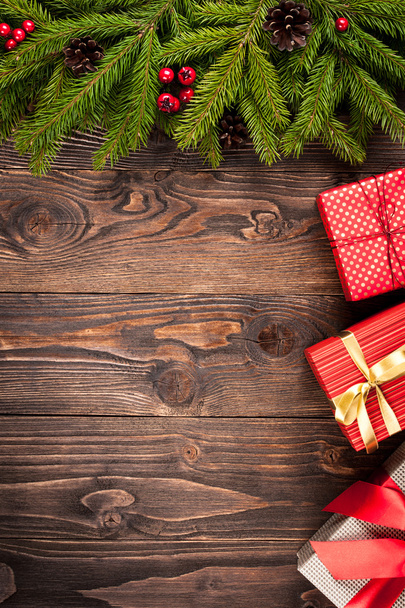 Fir tree and gift boxes on dark wooden background - Foto, Imagen