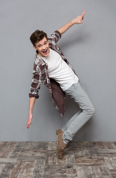 Full length portrait of excited dancing young man - Zdjęcie, obraz