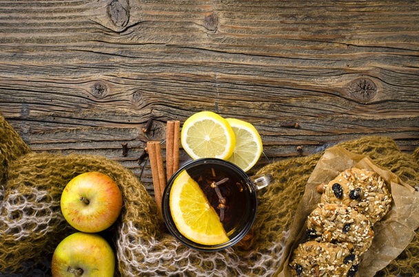Cup of hot tea with fruits and cookies on wooden table - Fotografie, Obrázek