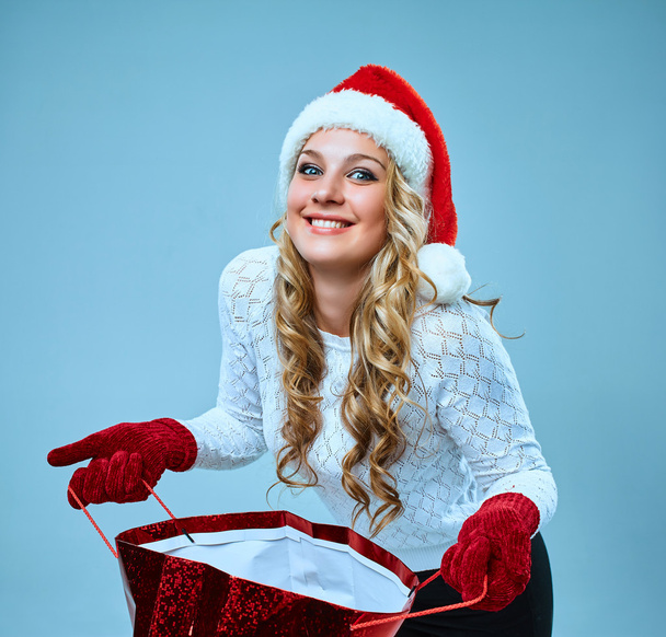 Beautiful young woman in Santa Claus clothes - 写真・画像