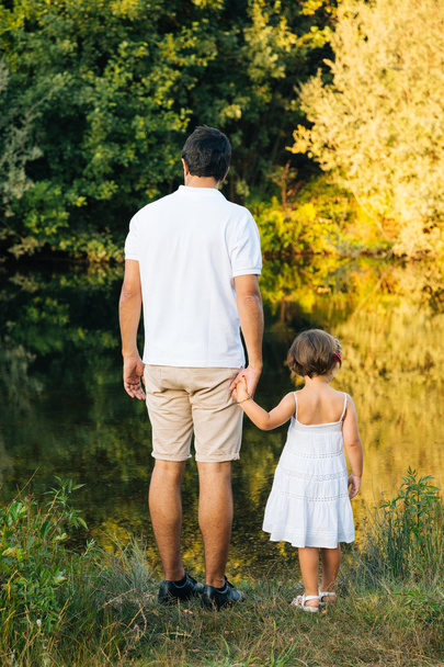 Father and daughter at the river - Photo, image