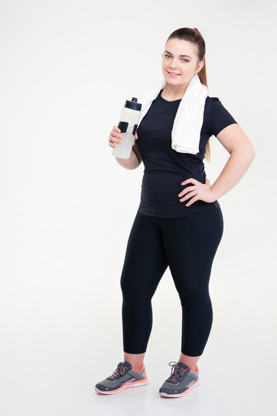 Fat woman in sports wear holding shaker - Foto, Imagen