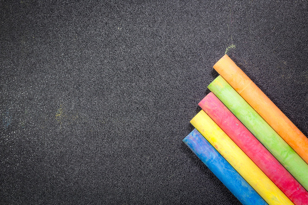 Row of rainbow colored chalk on blackboard - Photo, Image