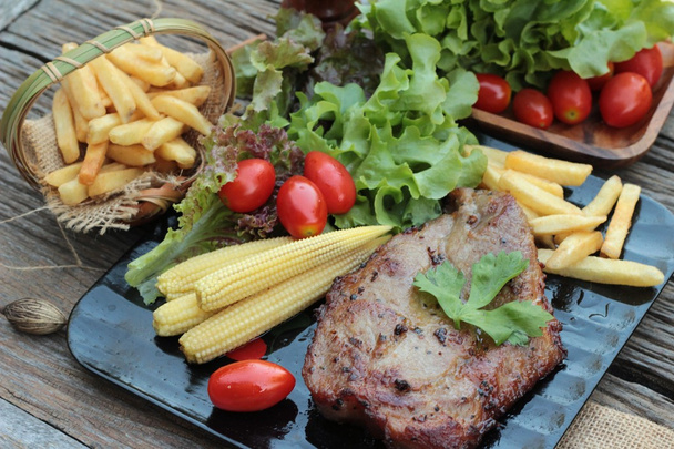 Pork steak of delicious with vegetable and tomato. - Photo, Image