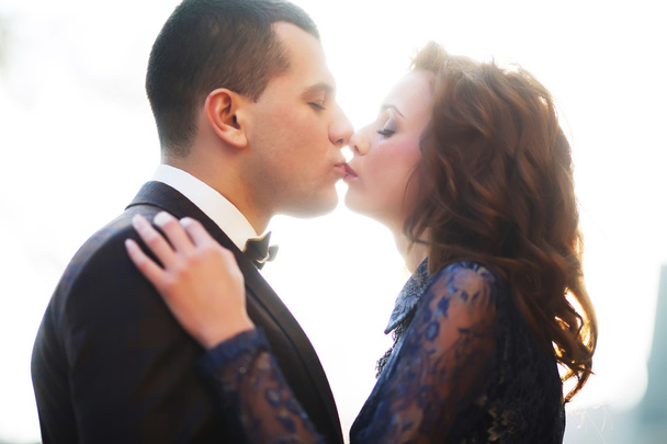 Couple kissing at sunset. wedding day, closed eyes - Фото, зображення