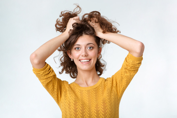 Smiling casual woman holding her hair - Zdjęcie, obraz