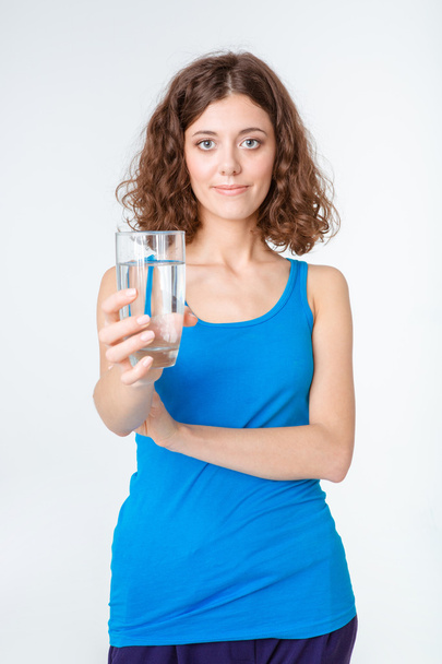 Woman giving glass with water at camera  - Фото, изображение