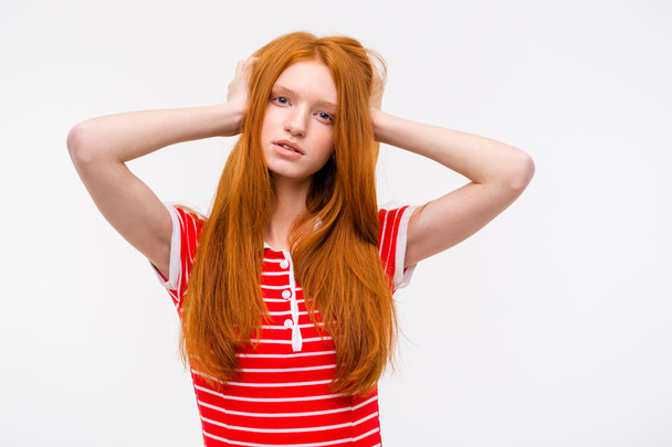 Thoughtful pretty redhead female holding head in hands - Fotografie, Obrázek