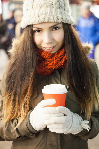 Young girl with hot coffee in cold evening - Photo, image