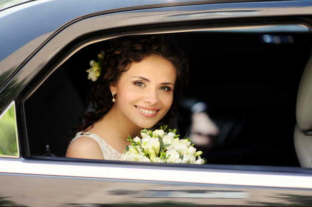 Beautiful bride with bouquet of flowers outdoor - Fotó, kép