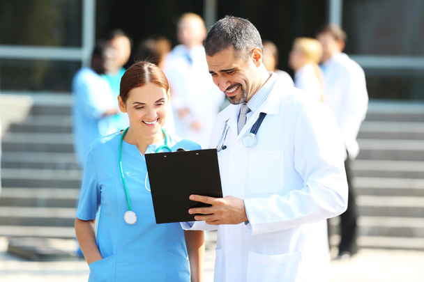 Medical concept - two doctors with stethoscopes and prescription clipboard - Photo, Image