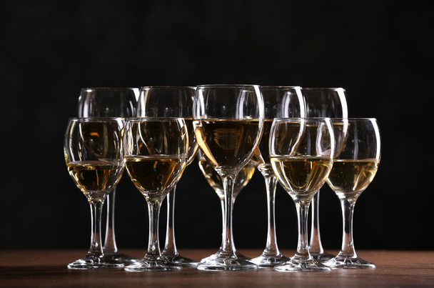 Half full wine glasses on a table - Fotó, kép