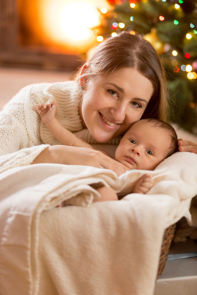 portrait of mother and baby boy at decorated room for Christmas - Photo, Image