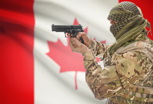 Male in muslim keffiyeh with gun in hand and national flag on background - Canada - Zdjęcie, obraz