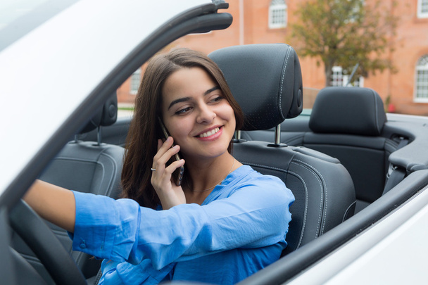 Businesswoman talking on mobile phone in car - Photo, Image