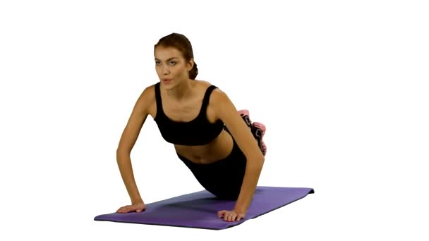 woman in a traditional yoga pose, white background, stretching. Gym - Záběry, video