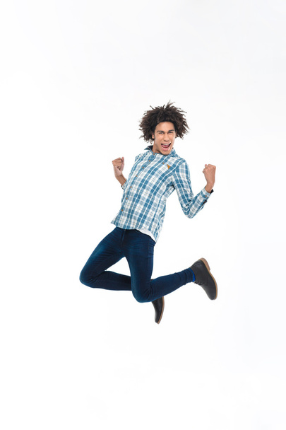 Cheerful afro american man jumping  - Photo, image