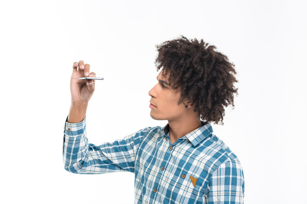 Afro american man looking on slim smartphone  - Fotó, kép