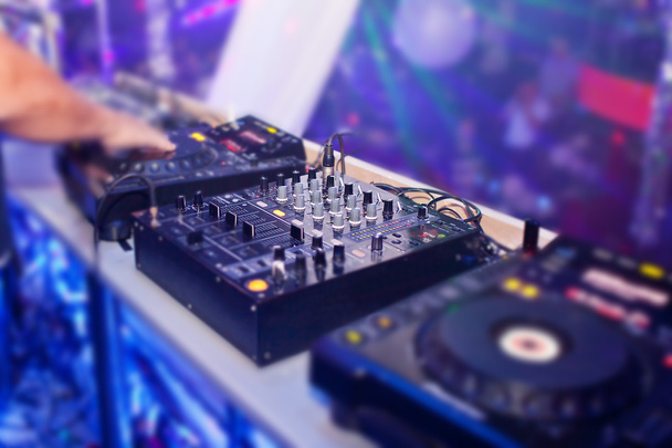 DJ mixing music on console at the night club - Φωτογραφία, εικόνα