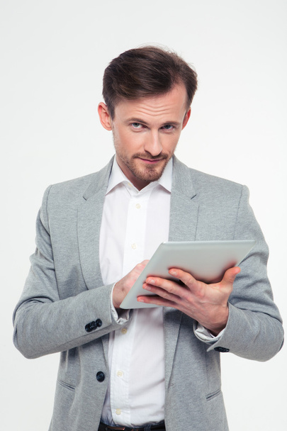 Businessman using tablet computer and looking at camera - Φωτογραφία, εικόνα