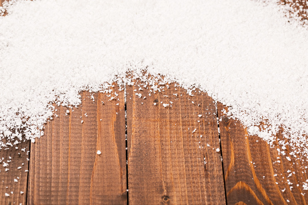 Christmas snow on wooden background - Foto, afbeelding