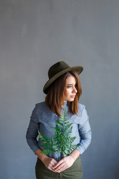 Portrait of  girl with a plant in hands - Zdjęcie, obraz
