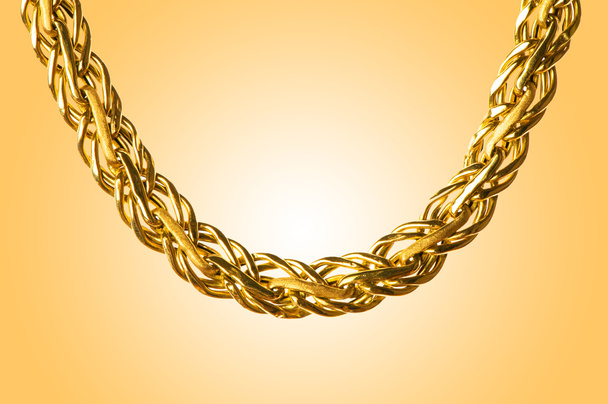 Golden jewellery against gradient background - Photo, Image