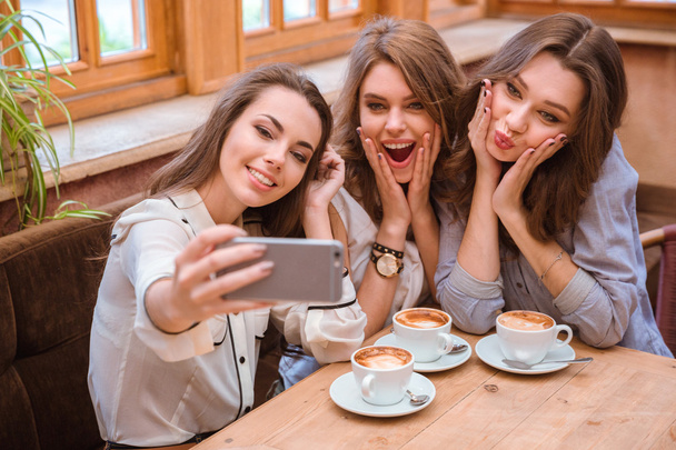 Three women making selfie photo in cafe - Fotografie, Obrázek