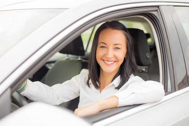 Smiling woman driving car - Photo, Image