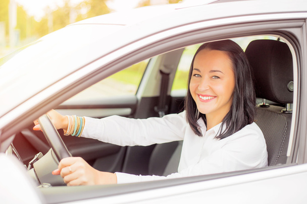 Smiling woman driving car - 写真・画像