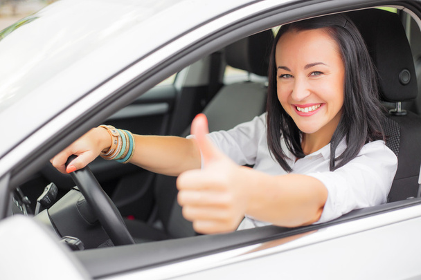 Female driver showing thumbs up - Фото, изображение