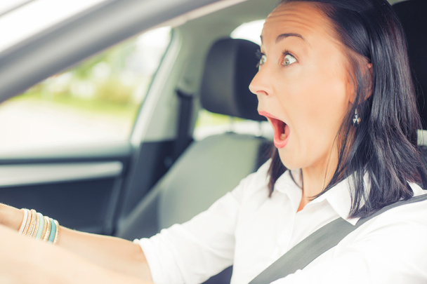 Surprised woman in the car - Foto, Imagen