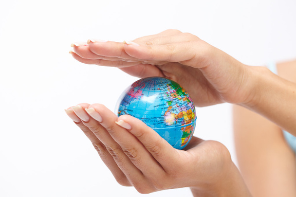 earth globe between woman's palms - 写真・画像
