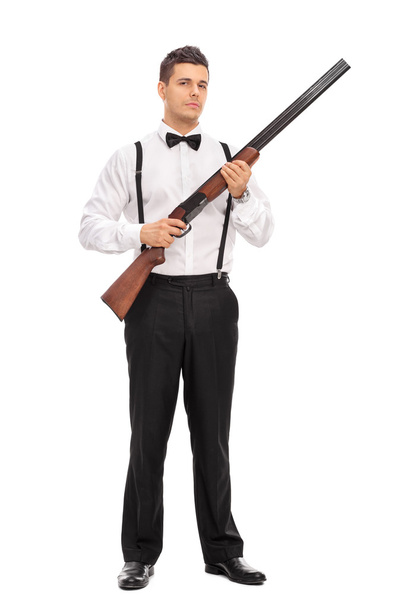 young man holding a shotgun rifle - 写真・画像