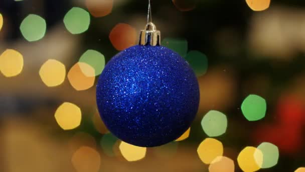 Christmas blue ball shakes at background bokeh - Footage, Video