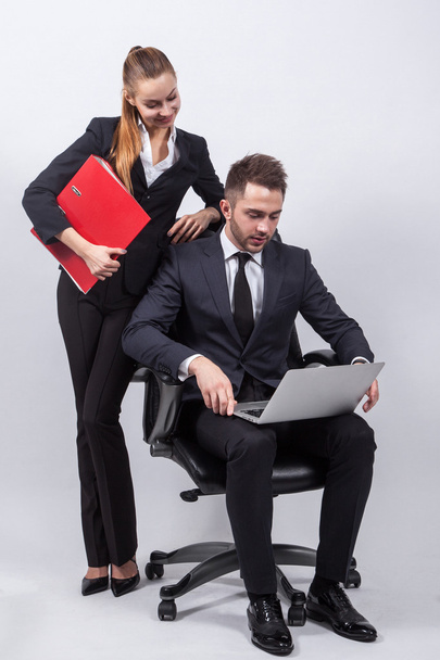 Young creative businesswoman sitting on a chair with a laptop on - Photo, Image