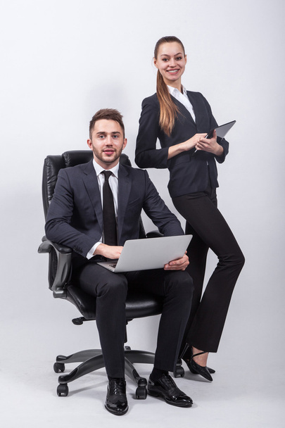 young creative expert sitting in a black leather office chair wi - Foto, imagen