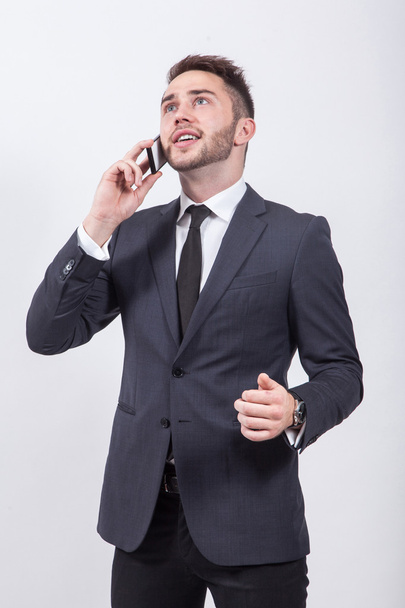successful young businessman in classical stylish suit talking o - Fotoğraf, Görsel