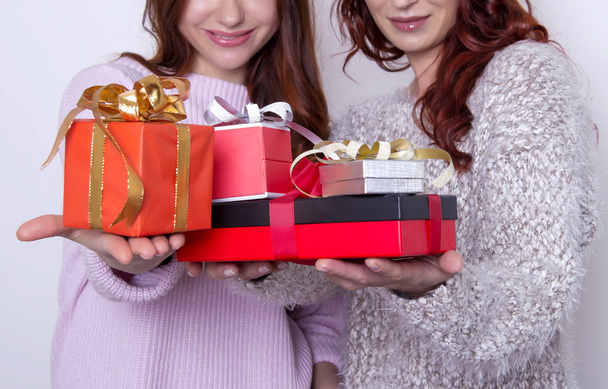 two beautiful young friends with presents - Фото, изображение