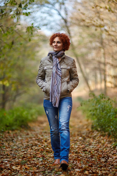 Woman having a walk in the woods - Fotoğraf, Görsel
