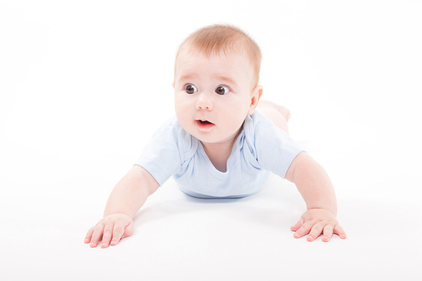 baby in the body lying on his stomach on a white background and  - Foto, Imagen